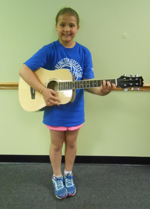 Maddie plays guitar at AMA Dance and Music School in Des Plaines